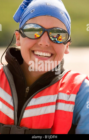 Portrait d'une jeune femme portant des lunettes de soleil en raison de son bateau et d'autres au cours de son voyage de rafting Southcentral Alaska Banque D'Images