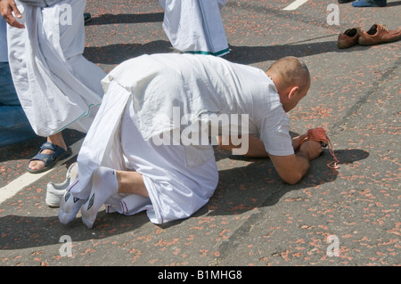 L'homme se prosterne à 40e en face de la divinité au char Rathayatra Hare Krishna Festival à Londres Banque D'Images