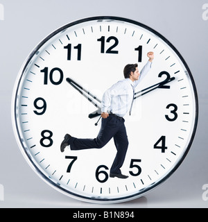 Businessman fonctionnant sur une horloge Banque D'Images