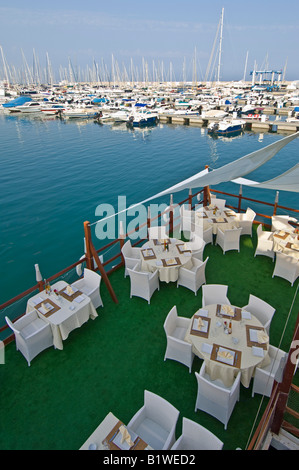 Tables prêt pour dîner dans un restaurant au bord de l'exclusif dans la marina Yasmine Hammamet, Tunisie. Banque D'Images