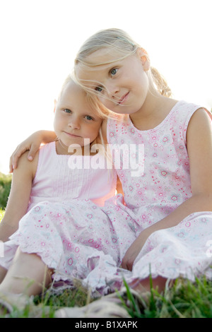 Portrait de deux amies de mettre leurs bras autour de leurs épaules en été, piscine extérieur Banque D'Images