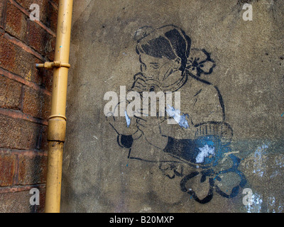 Style Banksy Stencil Graffiti sur Brick Lane, Shoreditch, London Banque D'Images