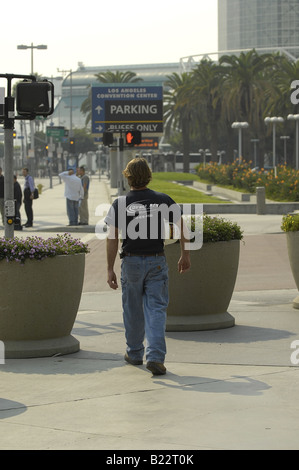 Un travailleur de la construction promenades le long du trottoir près du centre de convention de Los Angeles portant son casque de sécurité. Banque D'Images