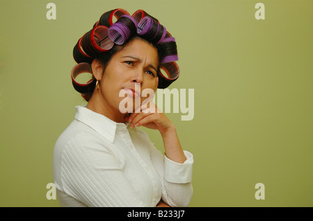 Woman wearing hair rollers Banque D'Images