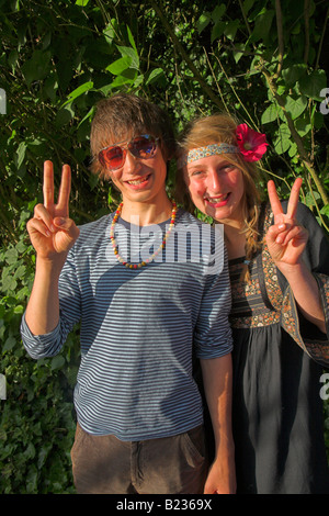 Garçon et fille hippie couple avec deux doigt peace sign Banque D'Images