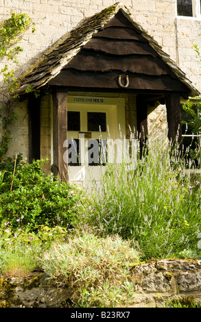 Porte avant et porche d'un chalet rustique français dans le village de Cotswold Ashton Keynes dans le Wiltshire, England, UK Banque D'Images