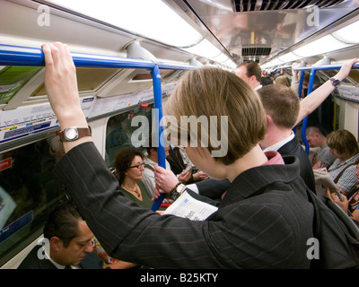 Les gens qui voyagent le métro de Londres transport durant les heures de pointe, en Angleterre, Royaume-Uni Banque D'Images