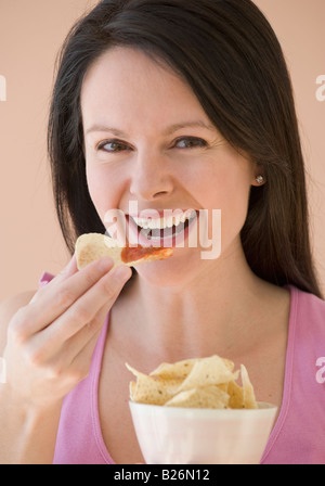 Woman eating chips et trempette Banque D'Images