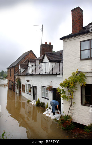 Un résident de ce pays d'INONDATION TEWKESBURY GLOUCESTERSHIRE BARRICADES LA PORTE D'UN CHALET AVEC DES SACS DE JUILLET 2007 UK Banque D'Images