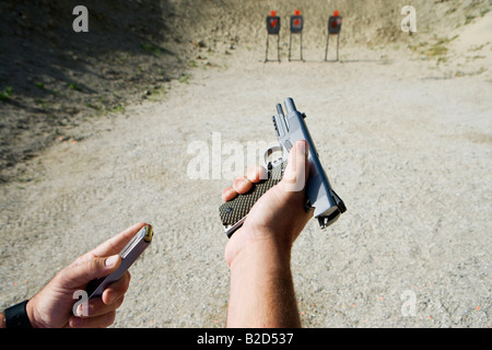 L'homme d'armes de chargement à portée de tir, se concentrer sur les mains Banque D'Images