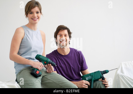 Portrait of a young woman holding drills Banque D'Images