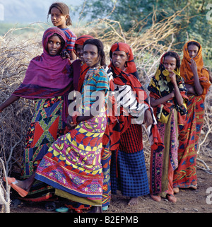 Loin filles portent des vêtements colorés et attrayants ont coiffures, qui sont typiques des jeunes filles de la tribu. Banque D'Images