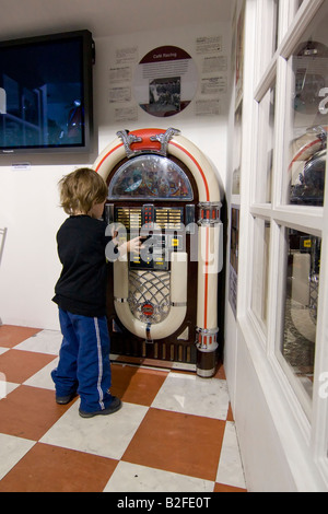 Jeune garçon debout à jukebox Banque D'Images