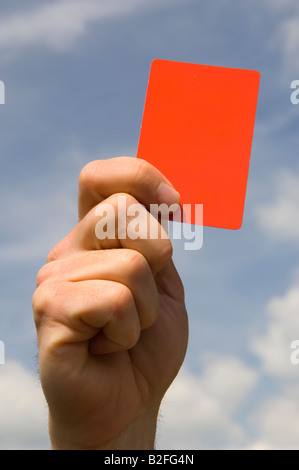 Une main tenant un carton rouge Banque D'Images