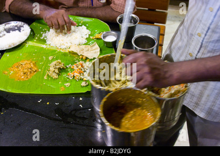 Au service de plus de nourriture sur un Thali à Madurai Inde du Sud Banque D'Images