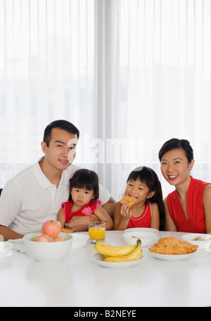 Portrait of a young couple having breakfast avec leurs enfants Banque D'Images