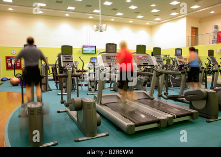 Les gens dans la salle de sport sur l'exécution de machines virtuelles, floue pour la vitesse et la puissance de sport Spa santé générique effets Banque D'Images