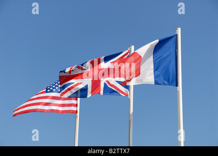 Drapeaux des UK, USA et de la France contre le ciel bleu Banque D'Images