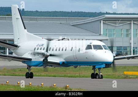 Saab SF 340B Turbo Prop avion de passagers appartenant à Flybe exploité par Loganair à l'aéroport d'Inverness Banque D'Images