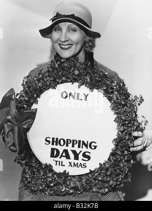 Femme avec signe avec certain nombre de jours jusqu'à Noël Banque D'Images