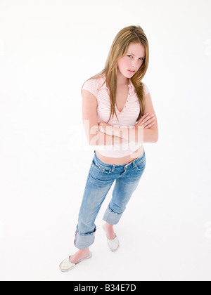 Teenage girl with arms crossed froncer Banque D'Images