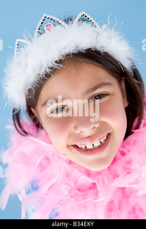 Jeune fille portant couronne et plume boa smiling Banque D'Images