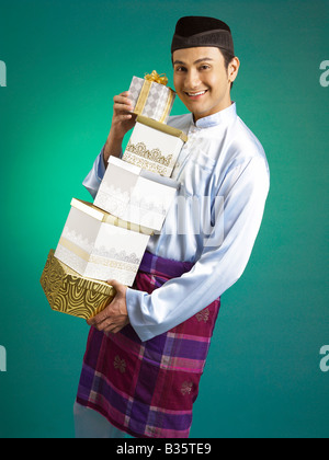 Un homme malais holding presents Banque D'Images