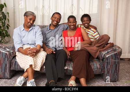 Three generation family on sofa in living room, smiling, portrait Banque D'Images