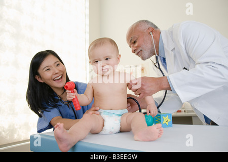 Un médecin et une infirmière examine un bébé Banque D'Images