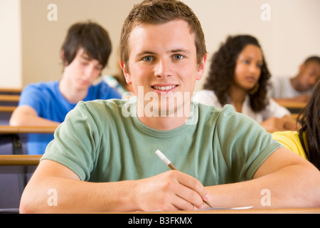 Student in class taking notes (selective focus) Banque D'Images