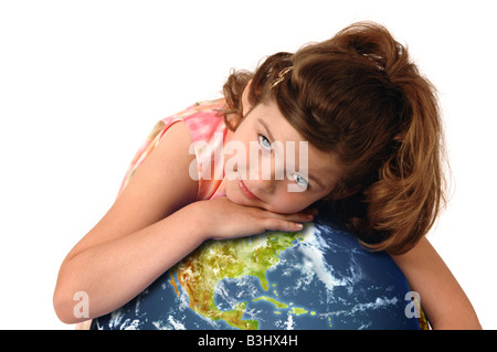 Little girl hugging planète terre contre fond blanc Banque D'Images