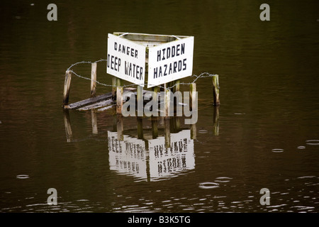 Un signe d'une carrière dans le comté de Durham, Angleterre, met en garde d'eau profonde et dangers cachés. Banque D'Images