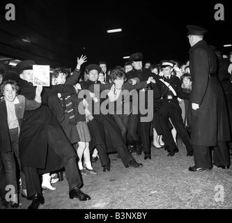 Groupe pop les Beatles Novembre 1963 Police détient retour fans et de la foule en attente d'avoir un aperçu de leurs idoles dans East Ham Banque D'Images