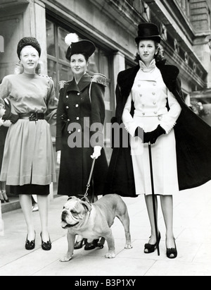 Mode Vêtements Femmes 1940 robes Femme portant Double breasted manteau épaulettes naval Nelson marcher un British Bulldog Banque D'Images