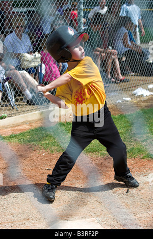 Un jeune homme se connecte avec l'entraîneur de baseball dans la petite ligue à pas variable. Banque D'Images