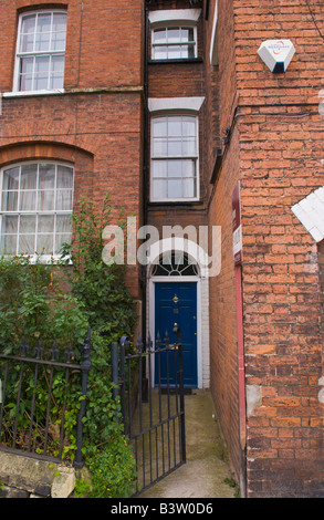 Avant bleu porte avec imposte vitrée semi-circulaire de l'entrée étroite de townhouse in Ludlow Shropshire England UK Banque D'Images