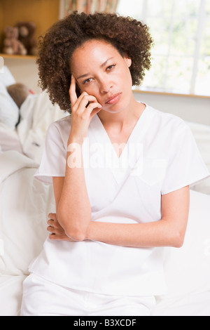 Nurse sitting on Hospital Bed Banque D'Images