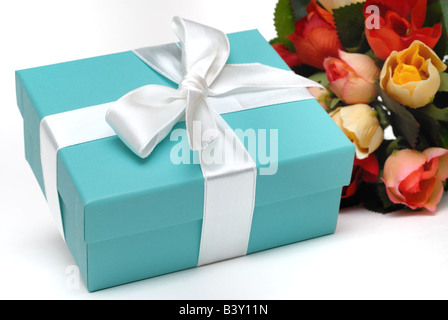 Une élégante boîte cadeau bleue peu que chacun souhaite recevoir avec un bouquet de fleurs Banque D'Images