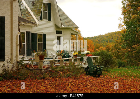 Amérique du Nord, USA, New York, Shrewsbury. Le porche d'une ancienne maison du Vermont entouré de couleurs d'automne. Banque D'Images