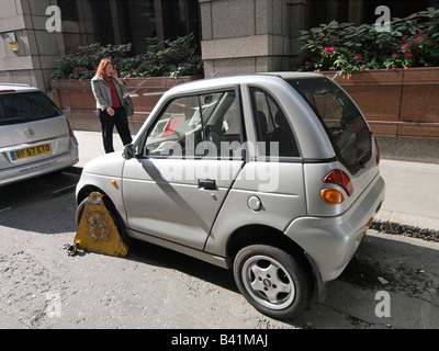 Stationné à tort Reva G Wiz voiture électrique avec wheelclamp London UK Banque D'Images