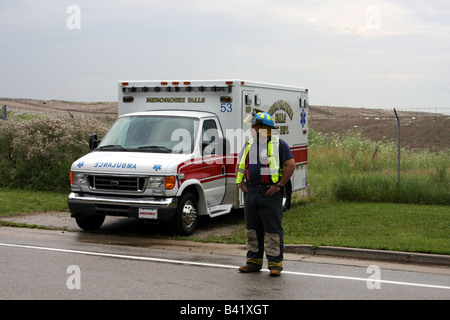 Une scène d'une urgence à l'EMT de diriger la circulation avec l'ambulance à l'arrière-plan Banque D'Images