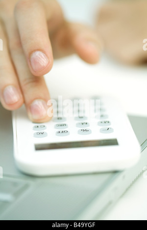 Woman's hand using calculator, extreme close-up Banque D'Images