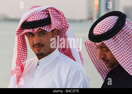 Le Qatar, au Moyen-Orient, Péninsule Arabe, Doha, deux hommes portant le costume traditionnel de thobe étage longueur robe chemise et gutra Banque D'Images