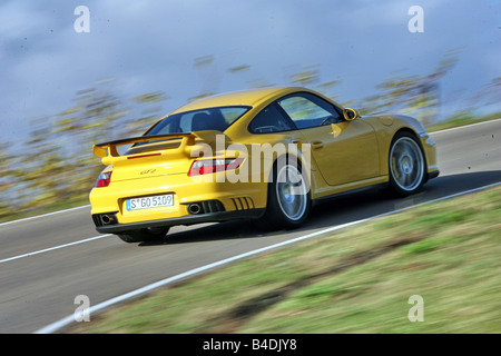 Porsche 911 GT2, l'année de modèle 2007-, jaune, conduite, déménagement, la diagonale de l'arrière, vue arrière, country road Banque D'Images