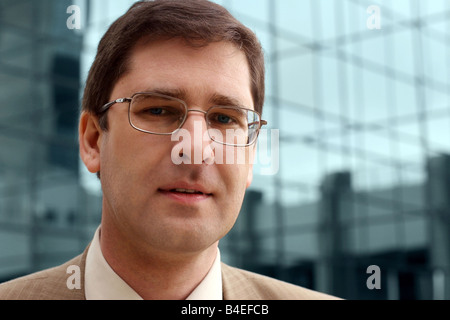 Jeune homme d'en face de l'immeuble de bureaux Banque D'Images