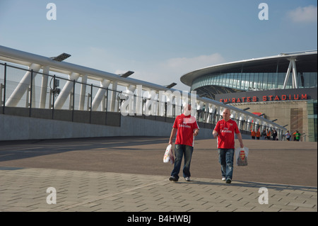 Deux supporters arsenal Arsenal port shirts et de transporter les sacs d'Arsenal. Banque D'Images