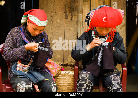 Zao rouge filles faisant la broderie (aka Dao rouge), le village lao Chai, SAPA, Vietnam Banque D'Images