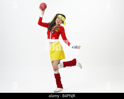 Young woman holding soccer ball, smiling, portrait Banque D'Images