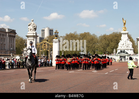 Agent de police métropolitaine monté s Garde à pied groupe jouant de militaires au cours de la relève de la garde au Palais de Buckingham Londres SW1 en Banque D'Images