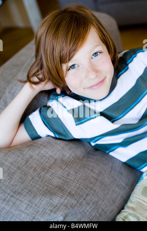 Portrait boy laying on a couch Banque D'Images